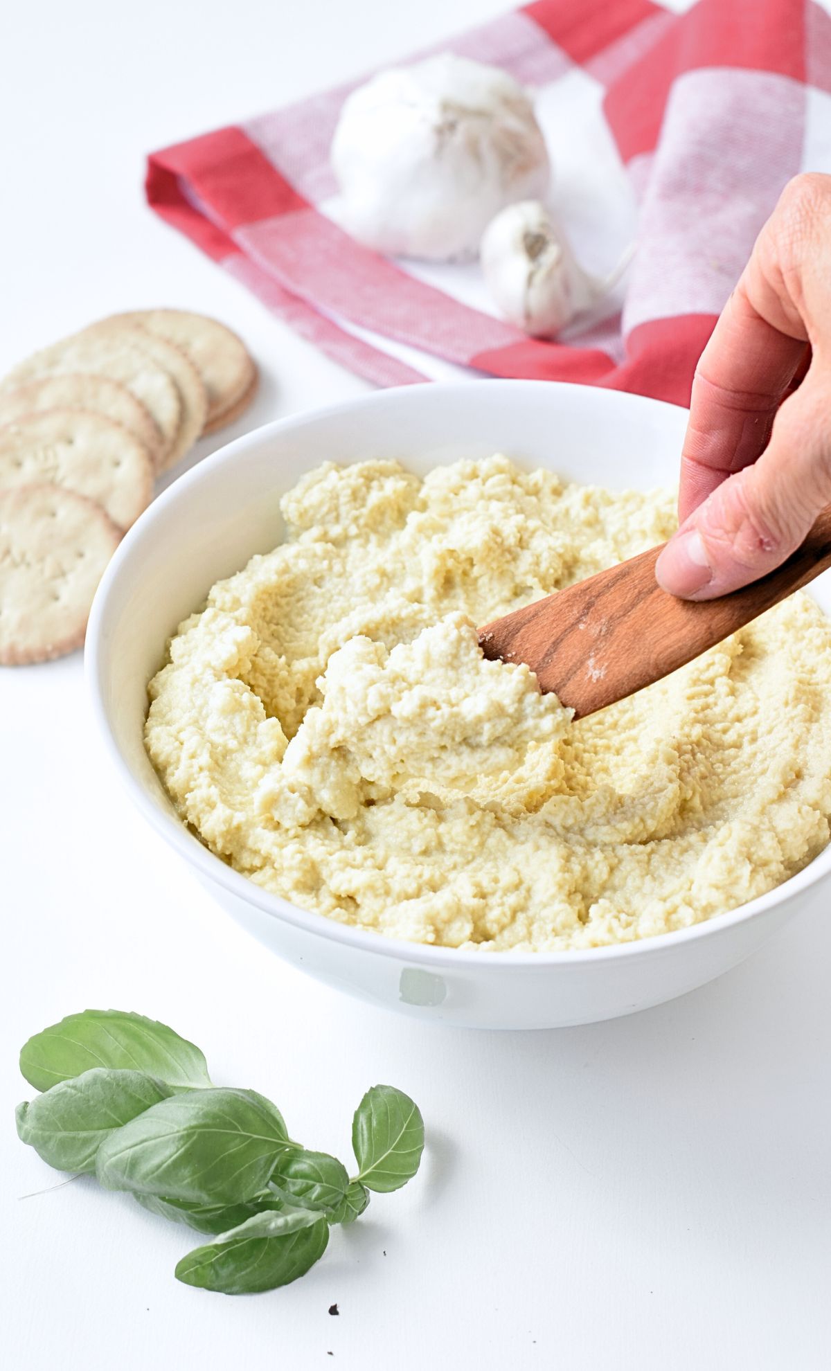 Vegan Almond Ricotta with a wooden spoon.