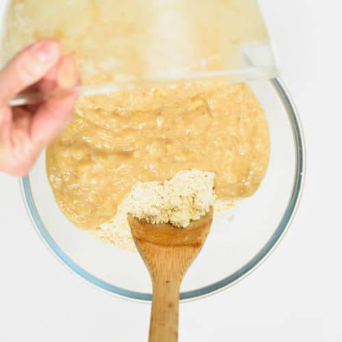 Pouring banana puree on Chickpea Flour Banana Bread batter