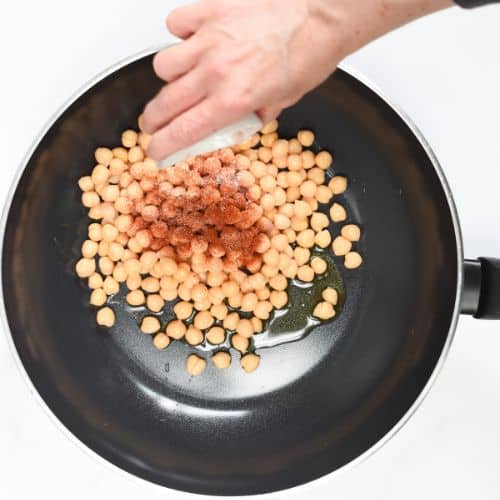 Toasting chickpeas with spices.