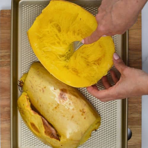 Shredding spaghetti squash with a fork.