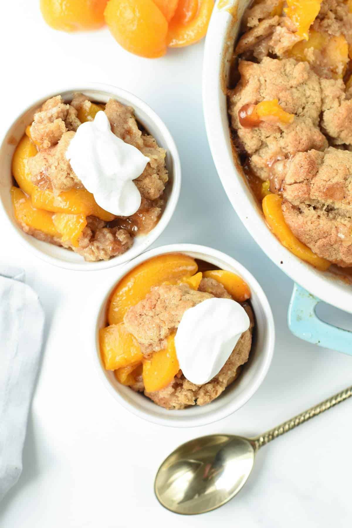 Vegan Peach Cobbler served in two ramekins