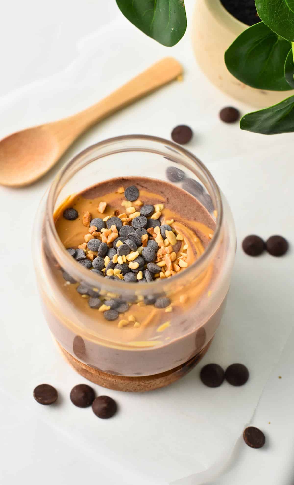 Chocolate Protein Yogurt in ajar with a wooden spoon.