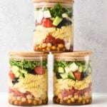 Pasta Salad With Balsamic Dressing in three glass jars.