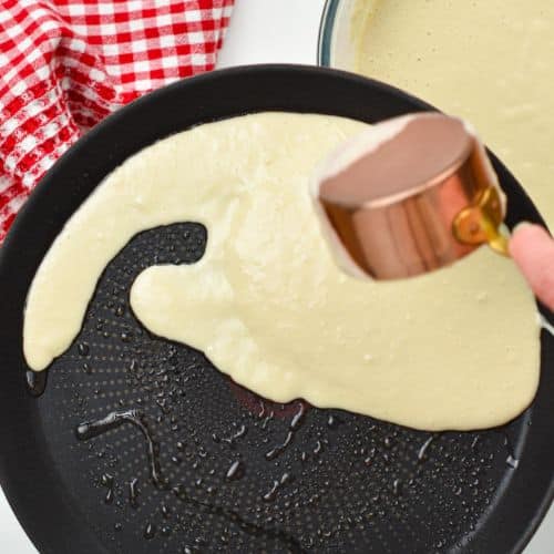 Pouring banana crepe batter on a crepe pan.