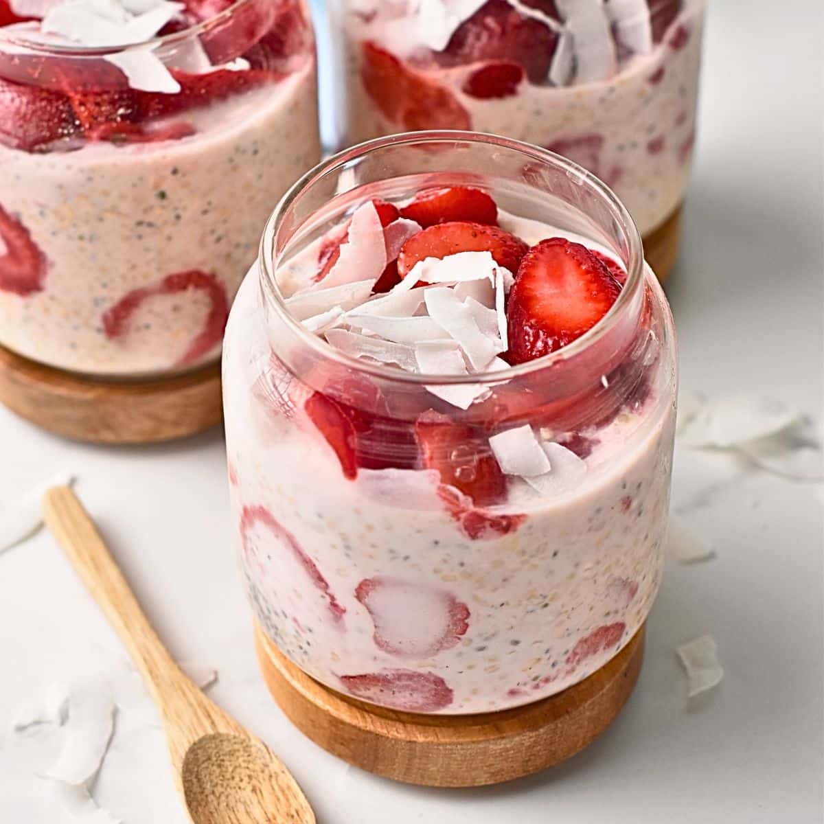 Strawberry Protein Overnight Oats in glass jars.