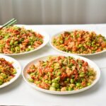 Four plates with vegan rice bake.