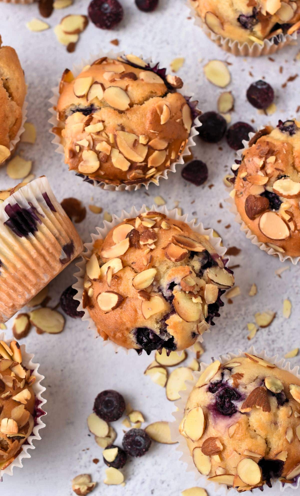 Blueberry Almond Muffins scattered on a table.