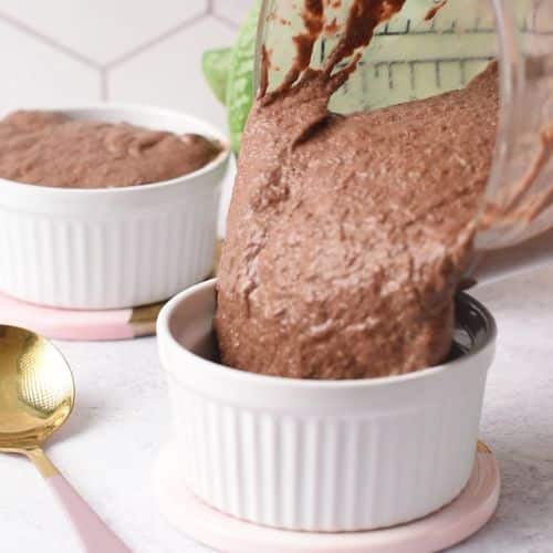 Pouring Blended Chia Seed Pudding into a ramekin.