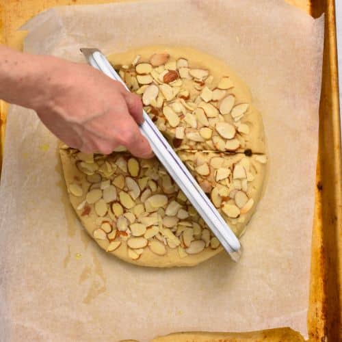 Slicing Almond Flour Scones on a baking sheet.