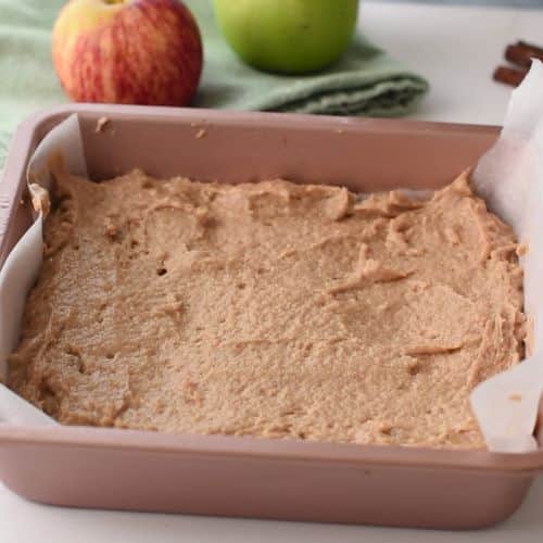 Applesauce cake batter in a square pan.