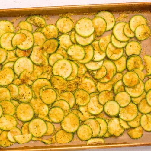 Sliced zucchini on a baking sheet.