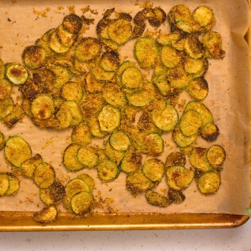 Baked zucchini on a baking sheet.