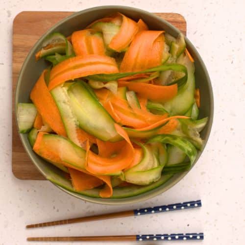 Carrot and cucumber ribbons on a plate.