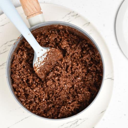 Stirring rice bubbles in chocolate mixture.