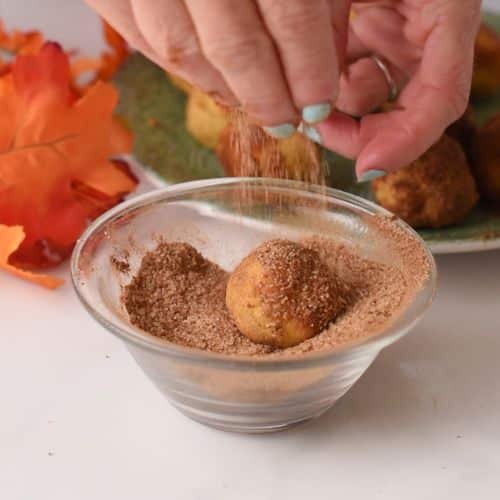 Rolling the Pumpkin Bites into cinnamon