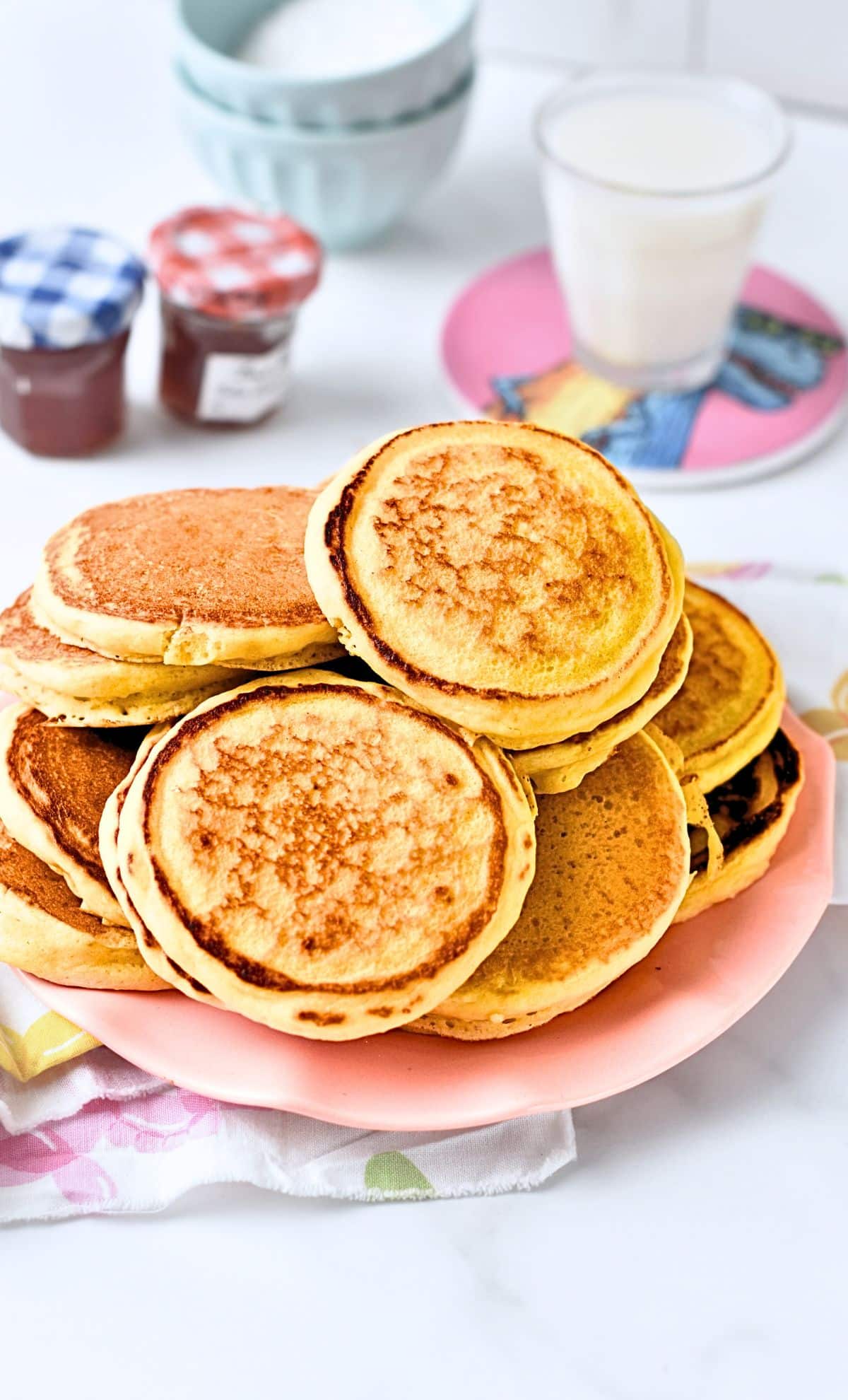 Pikelets stacked on a plate.