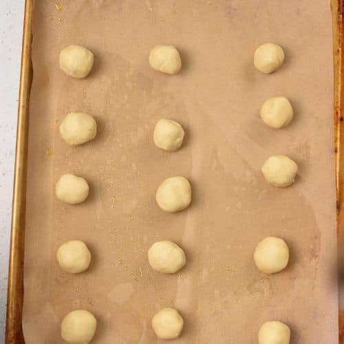 3-Ingredient Sugar Cookie dough balls on a baking sheet.