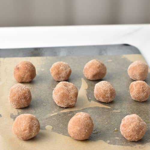 Almond Flour Snickerdoodle balls on a baking sheet.