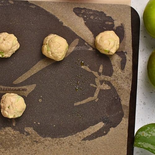 Formed Apple Donut Holes on a baking sheet.