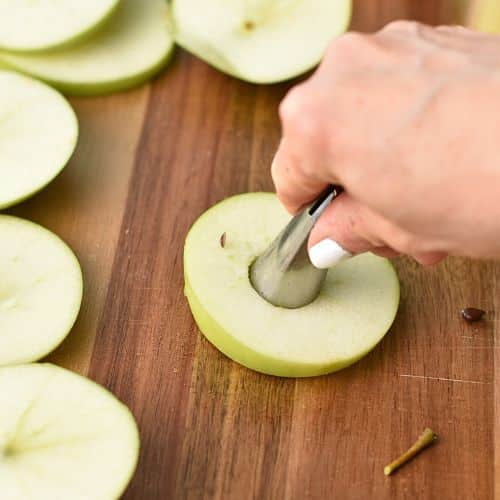 Coring apple slices for the Apple Rings.