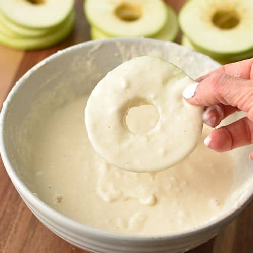 Dipping Apple Rings in the flour mixture.