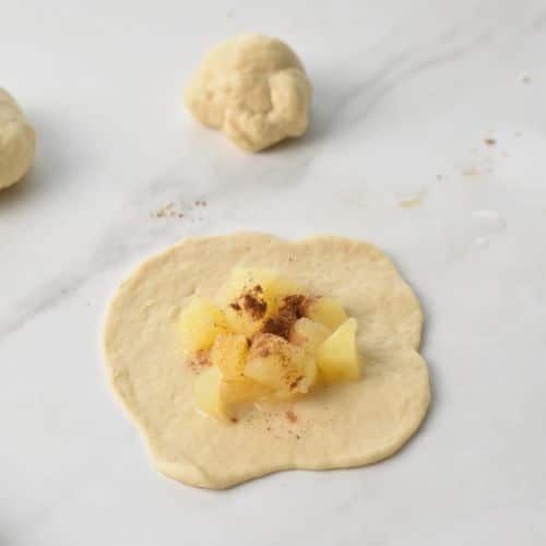 Adding diced apples and spice to the Baked Apple Donut dough.