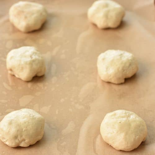 Baked Apple Donuts ready to bake on a baking sheet.