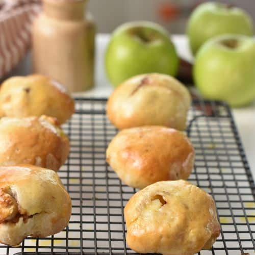 Brushed Baked Apple Donuts on a cooling rack.