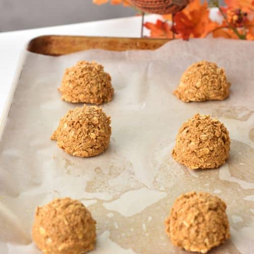 Healthy Pumpkin Oatmeal Cookie dough balls on a baking sheet.