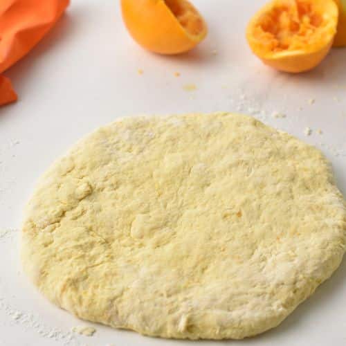 Flattened Orange Scone dough disc.