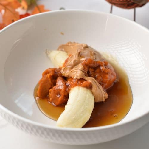 Banana and pumpkin puree in a mixing bowl.