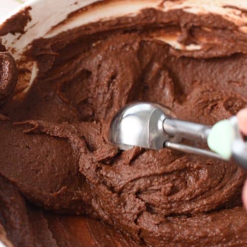 Scooping Pumpkin Brownie Bites dough with a scoop.