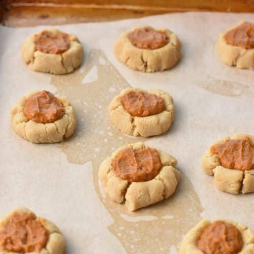 Pumpkin Pie Cookies with filling on a sheet.