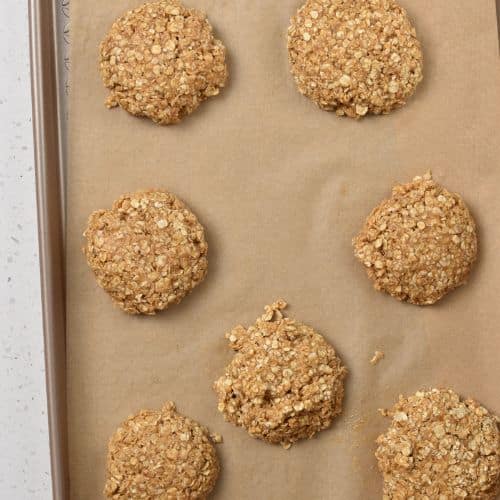 Flattened 3-Ingredient Oatmeal Cookies on a baking sheet.