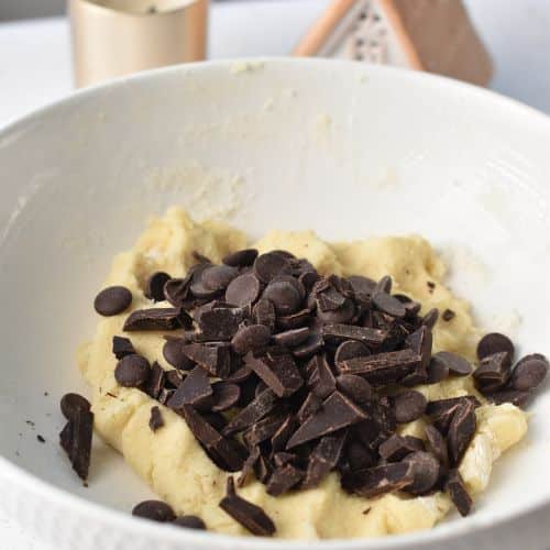 Adding chocolate chips to the 5-Ingredient Chocolate Chip Cookie dough.