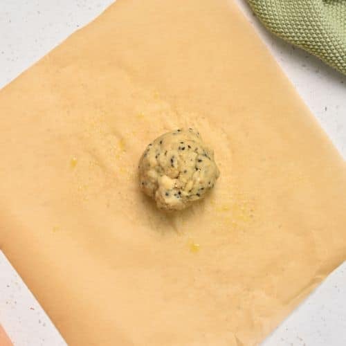 Almond Flour Cracker dough ball on baking paper.