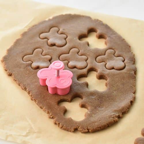 Cutting Almond Flour Gingerbread Cookies with cookie cut outs.