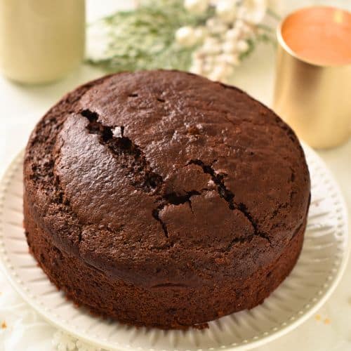 Easy Chocolate Cake cooling on a stand