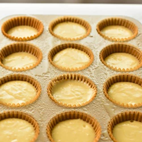 Easy Vanilla Cupcakes in a muffin tin ready to bake.