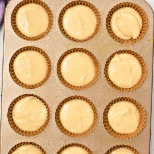 Easy Vanilla Muffins ready to bake in a muffin tin.