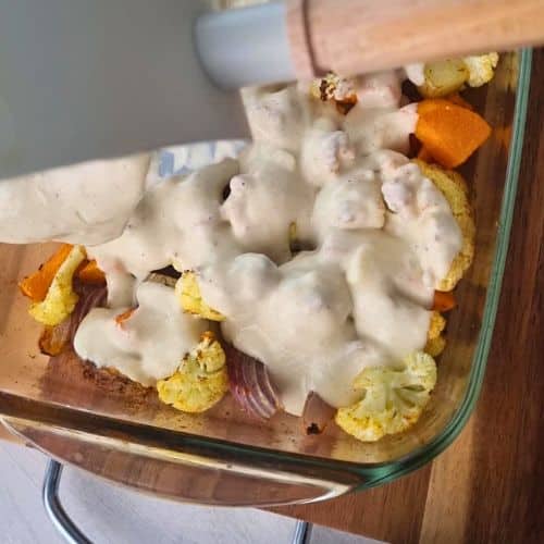 Pouring bechamel on Easy Vegetable Gratin