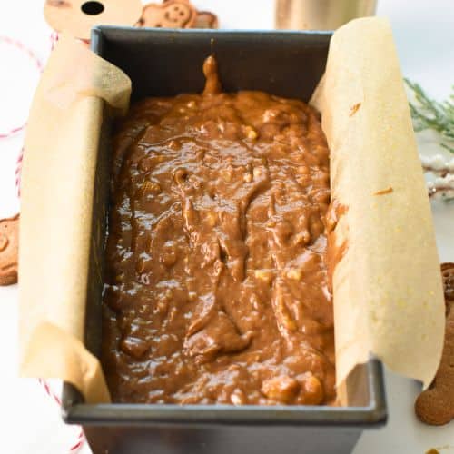 Gingerbread Banana Bread dough in a loaf pan ready to bake.