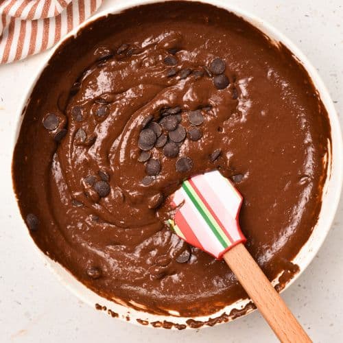 Adding chocolate chips to the Gluten-Free Chocolate Muffin batter.