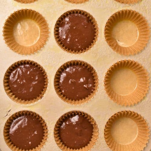 Filling muffin tin with Gluten-Free Chocolate Muffins.