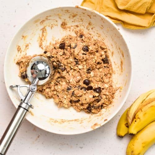 Healthy Breakfast Cookie batter in a mixing bowl with a cookie scoop.