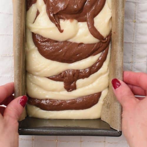 Jiggling Marble Pound Cake batter in a loaf pan.