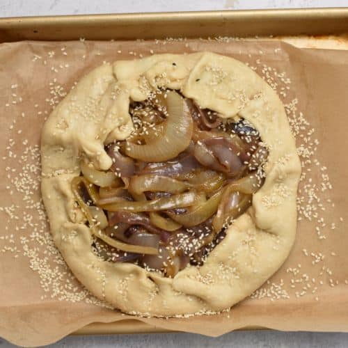 Onion Galette on a baking sheet ready to bake.