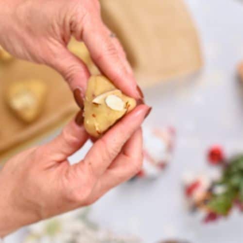 Forming the Almond Christmas Cookies in a triangle.