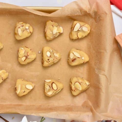 Almond Christmas Cookies ready to bake on a baking sheet.