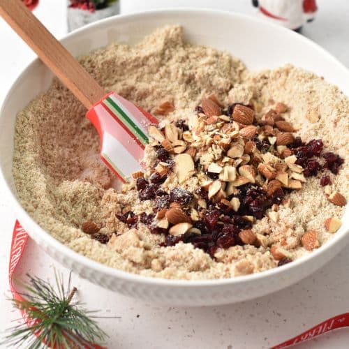 Adding chopped almonds and cranberries to the Almond Cranberry Cookie dough.